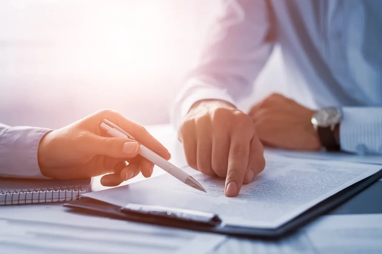 Two people reviewing a printed valuation document at a desk